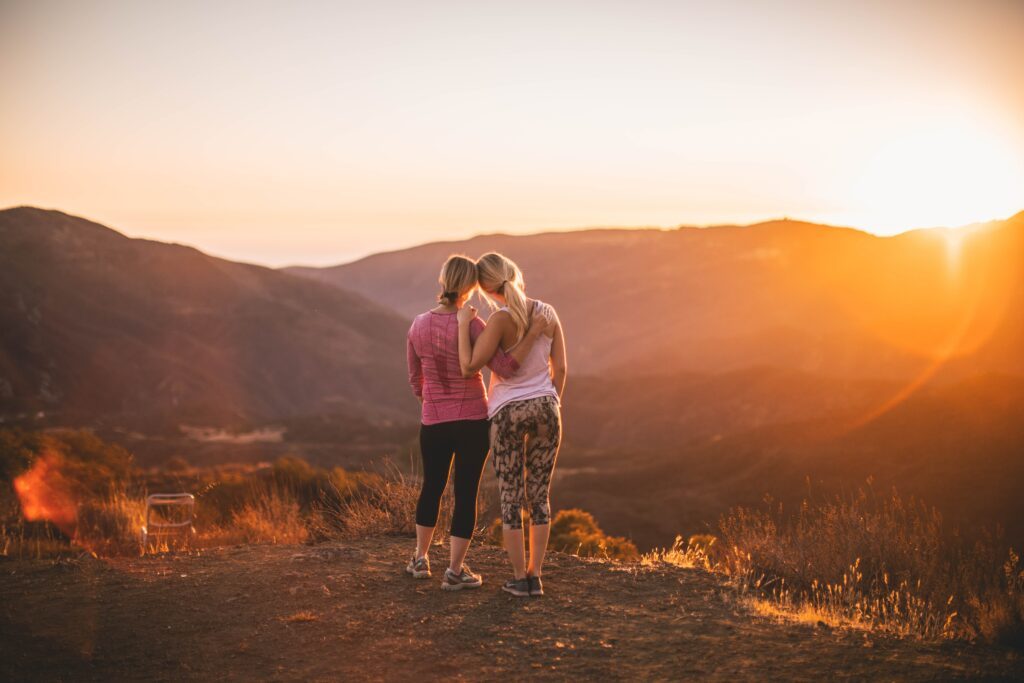 Photograph shows two women enjoying a sunset after Pilates and is above the form contact Pilates Perfect tutor Martine Cale who can also be contacted on 07970213830 